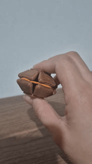 Brown Pop Fidget being squeezed