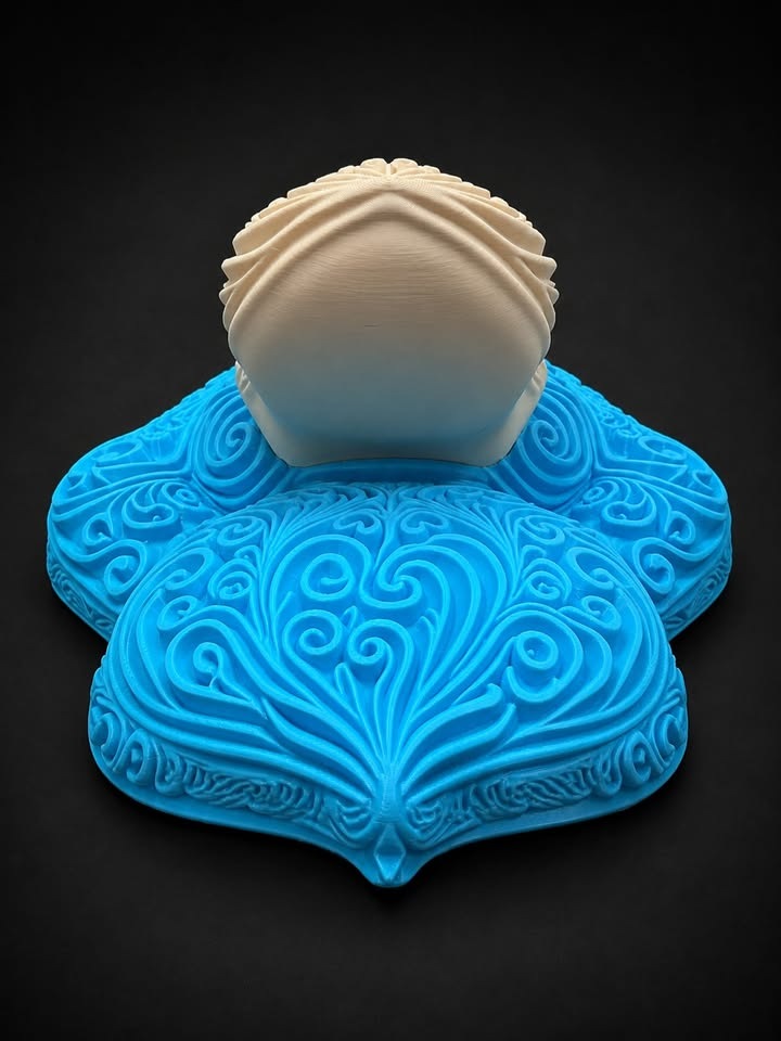 Low angled view of blue Psyduck filigree wall art showing the cream bill extending above its raised blue details.