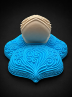 Low angled view of blue Psyduck filigree wall art showing the cream bill extending above its raised blue details.