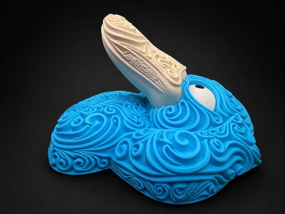 Side view of blue Psyduck wall art showing its prominent cream bill, white eye, and raised filigree profile.