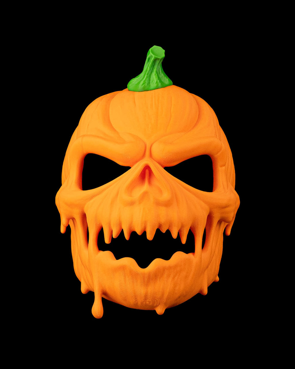 Close front view of the pumpkin mask showing scowling eye openings and dripping carved-pumpkin details.