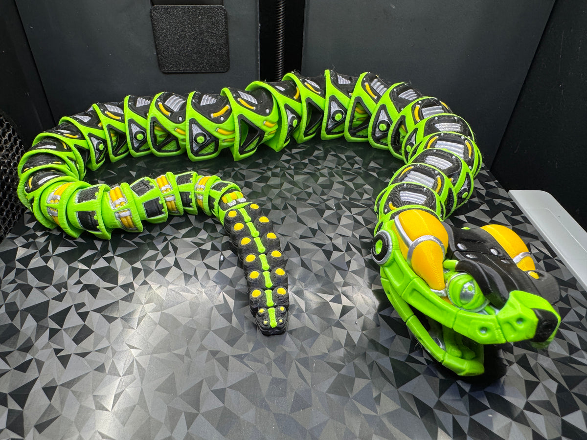 Full view of the articulated rattlesnake curled into a loop with its segmented rattle tail in the center.