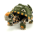 Front three-quarter view of the articulated robotic tortoise with olive green shell, orange accents, beige limbs, and black mechanical details.