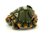 Side view of the robotic tortoise with its head and legs tucked close beneath the olive green mechanical shell.