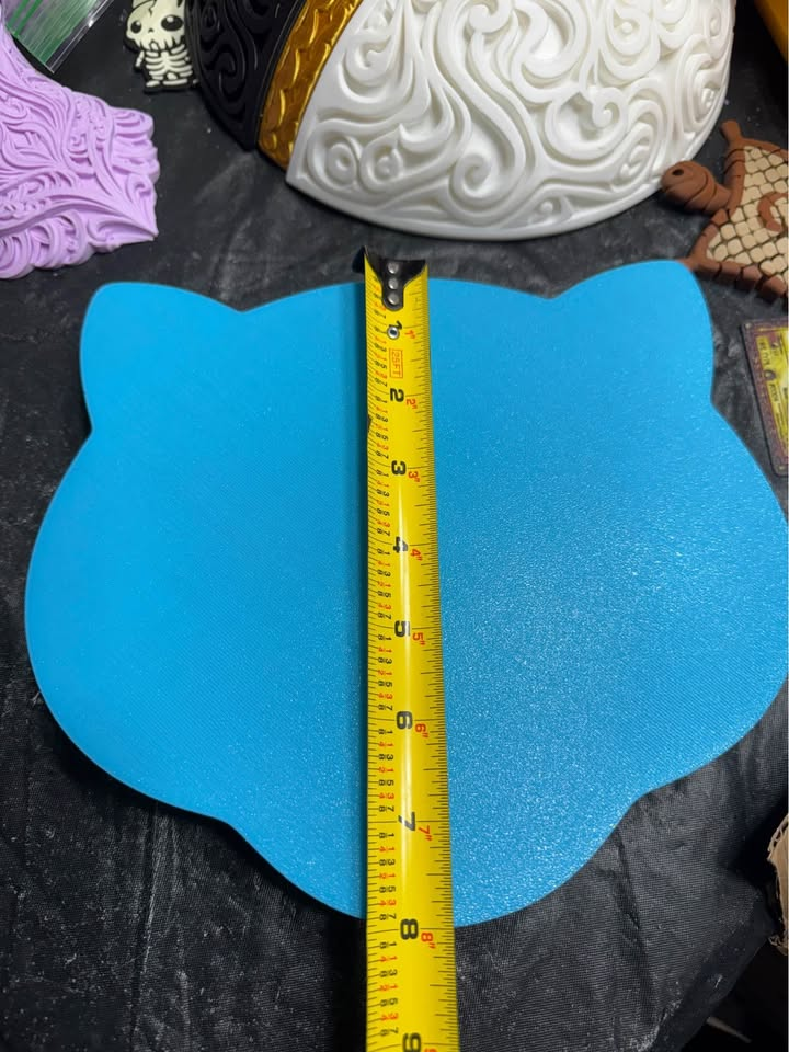 Blue back of Shiny Mew wall art with a vertical tape measure showing its approximate height.