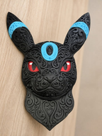 Black Shiny Umbreon wall art with raised filigree, blue forehead and ear rings, and red eyes against a wood background.