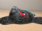 Side view of Shiny Umbreon wall art showing a raised black filigree muzzle, red eye, and blue ring accents on a wooden surface.