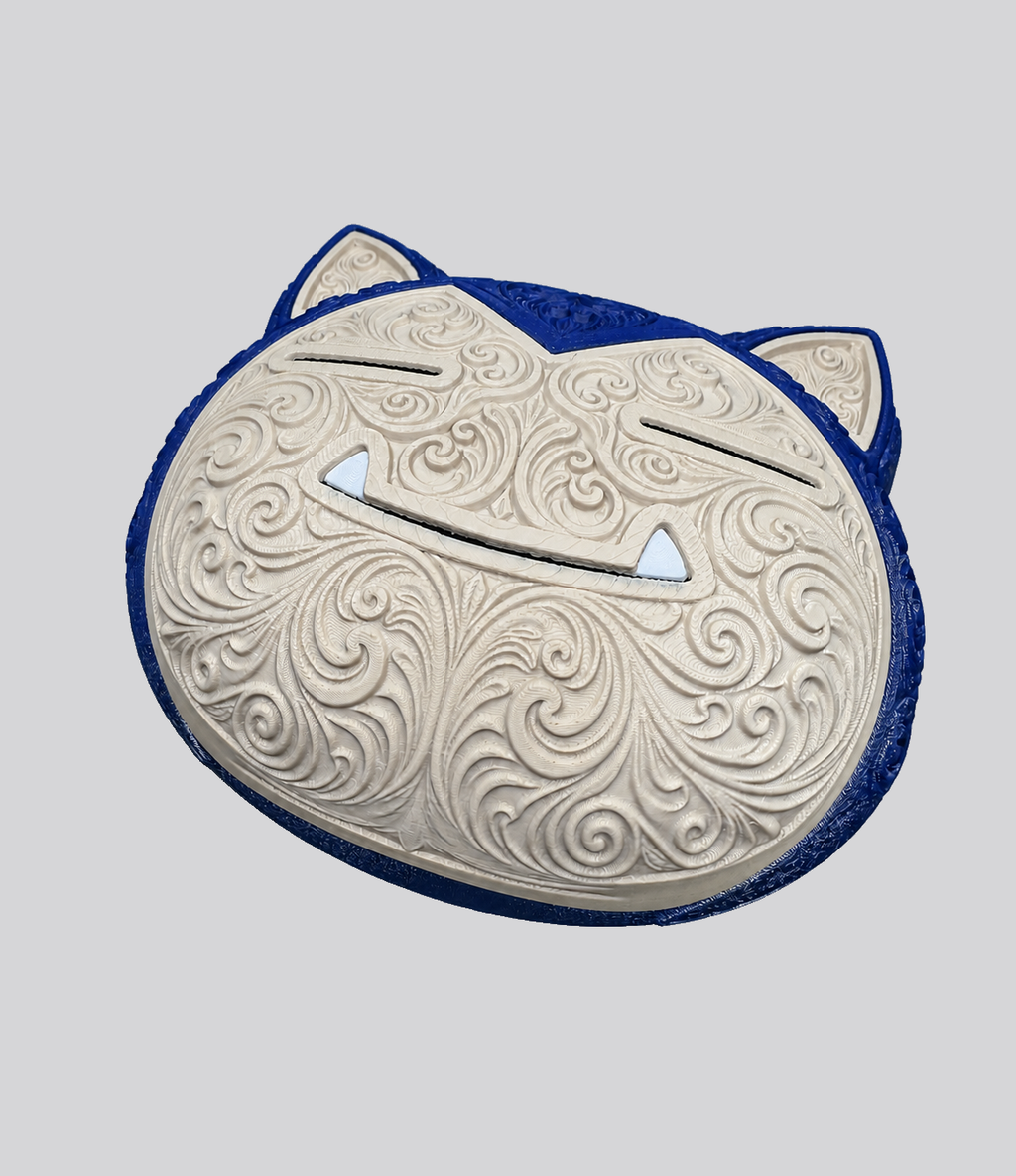 Angled view of Snorlax wall art showing raised cream filigree and a dark blue outer border on gray.