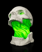 White Toxic Skull Lamp with an open jaw and bright green flowing center, shown from the front angle view against black.