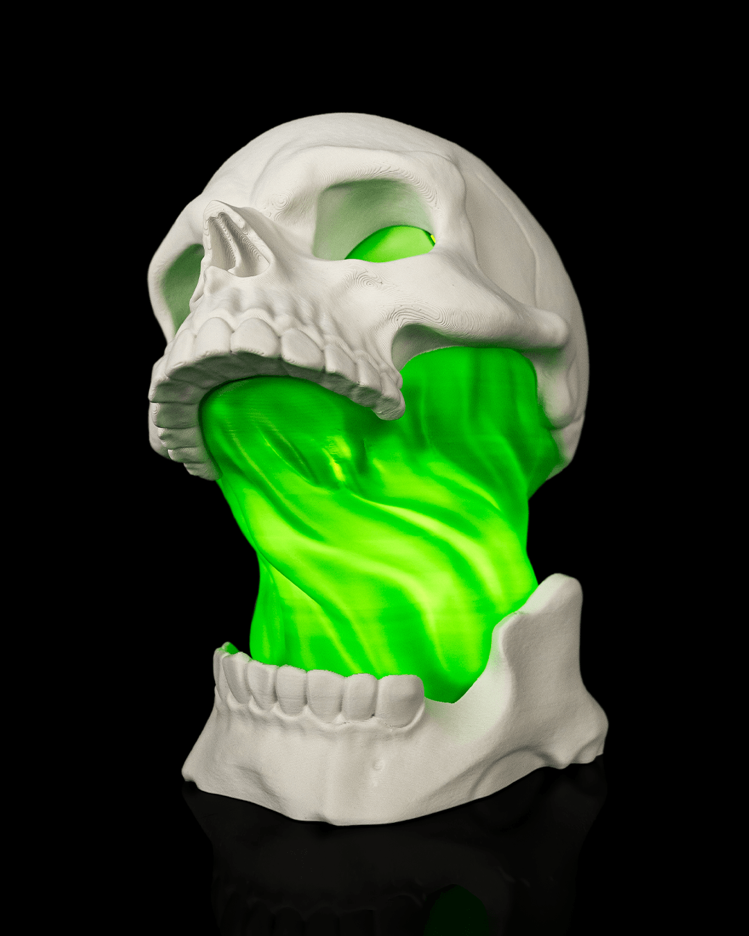 White Toxic Skull Lamp with an open jaw and bright green flowing center, shown from the front angle view against black.