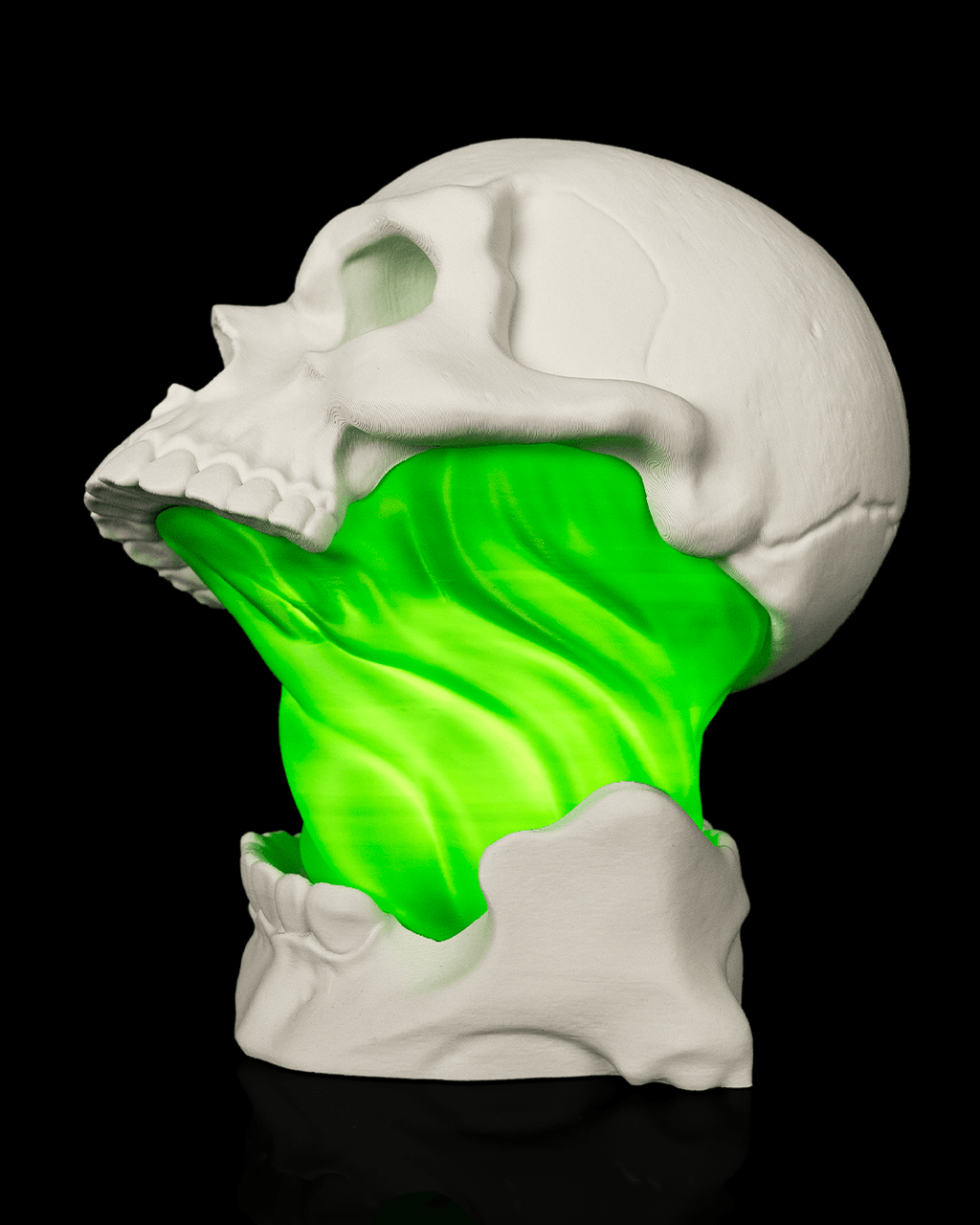 White Toxic Skull Lamp with an open jaw and bright green flowing center, shown from the side left view against black.