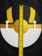 Back of black, gold, and white Ultra Ball wall art with two white joining pieces and a vertical tape measure showing its diameter.