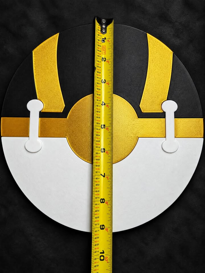 Back of black, gold, and white Ultra Ball wall art with two white joining pieces and a vertical tape measure showing its diameter.