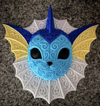 Front view of blue Vaporeon wall art with yellow ear fins and ornate white neck frill on a stone counter.