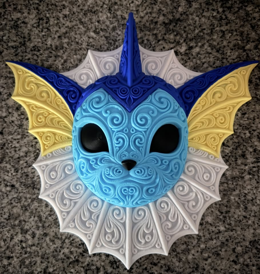 Front view of blue Vaporeon wall art with yellow ear fins and ornate white neck frill on a stone counter.