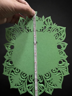 Green back of Venusaur wall art with a measuring tape showing its approximate height.