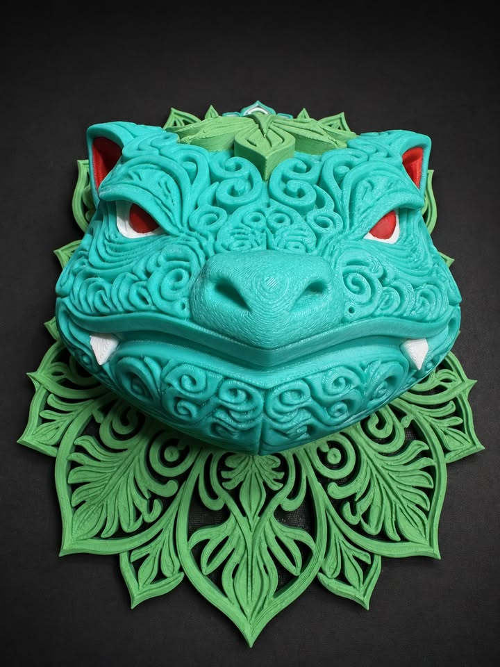 Venusaur wall art with teal raised filigree, red eyes and ear accents, white teeth, and green leafy scrollwork, shown from the front detail view.