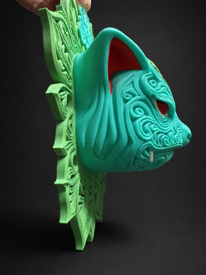 Side view of Venusaur wall art showing its teal raised face extending from a green leaf-patterned backing.